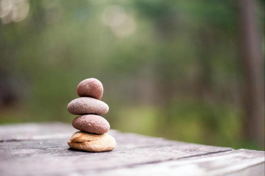 Stacked stones symbolizing mindfulness, acceptance, and emotional balance in ACT and DBT therapy