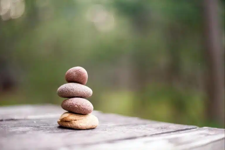 Stacked stones symbolizing mindfulness, acceptance, and emotional balance in ACT and DBT therapy