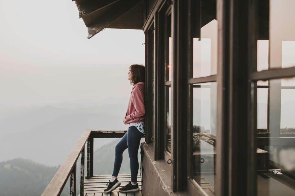 Woman outside cottage in athletic wear balancing wellness through DBT therapy treatment with therapists in Atlanta Georgia