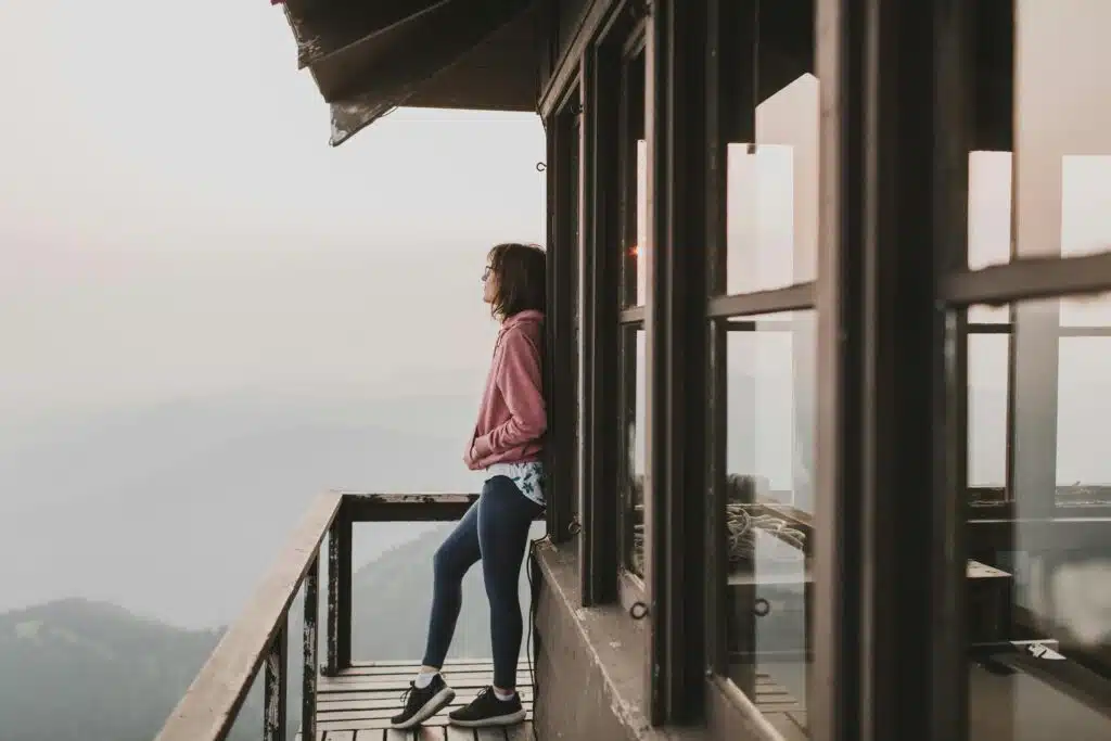 Woman outside cottage in athletic wear balancing wellness through DBT therapy treatment with therapists in Atlanta Georgia
