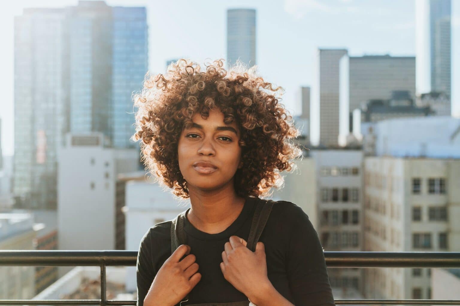 Black woman with backpack overlooking Atlanta city skyline feeling empowered after DBT therapy treatment in Georgia area