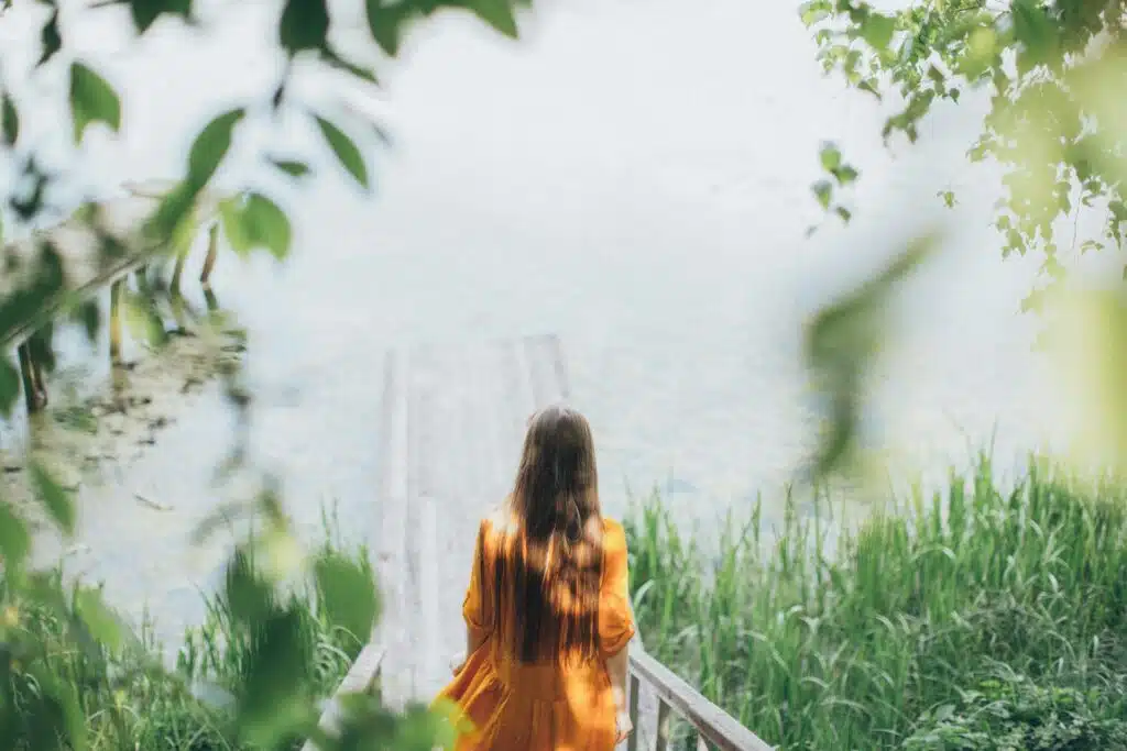 Woman in ethereal nature landscape practicing radical acceptance from DBT therapy sessions with Atlanta Georgia therapists