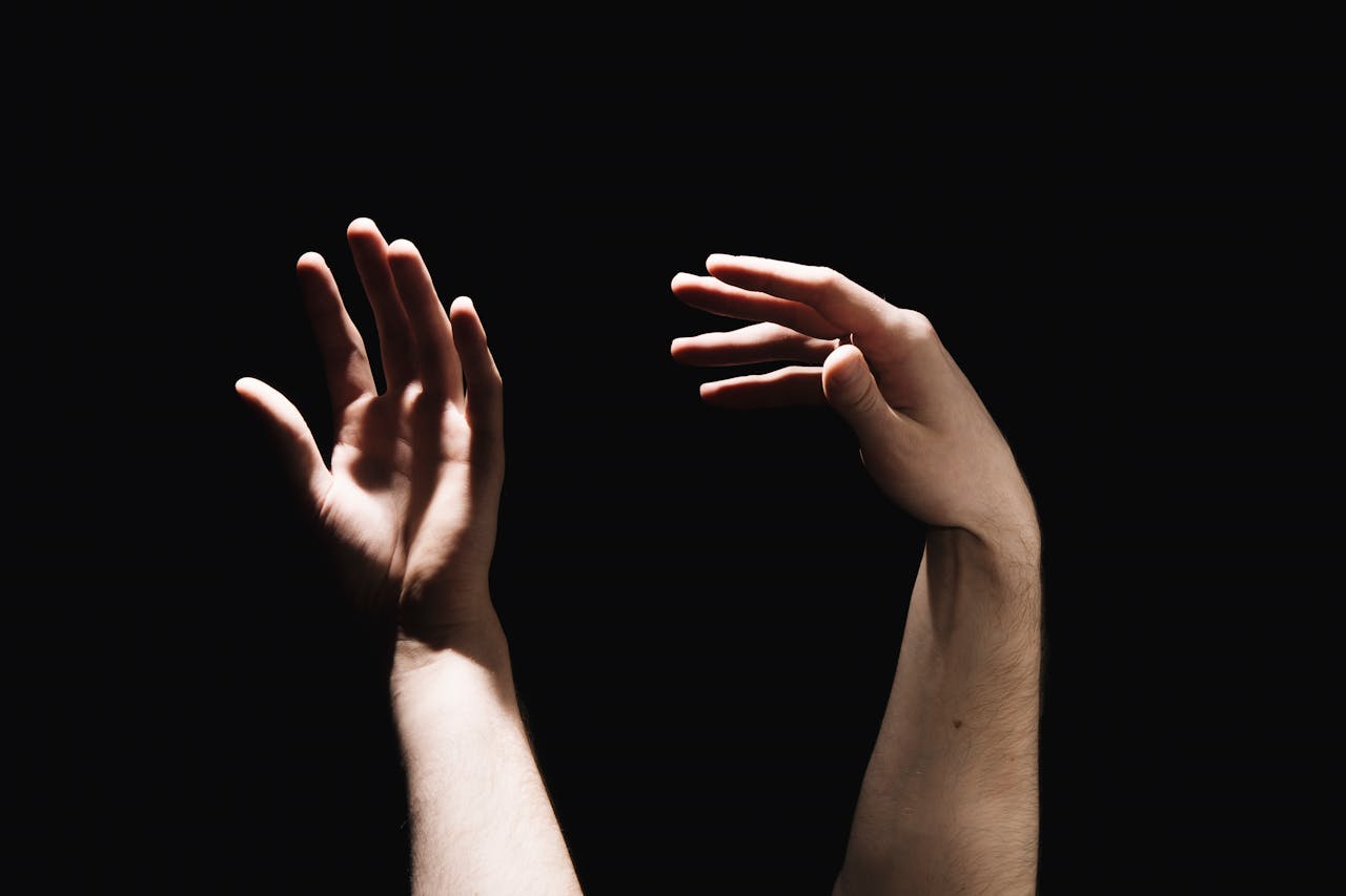 Hands reaching toward each other symbolizing support, trust, and the therapeutic relationship in anxiety therapy