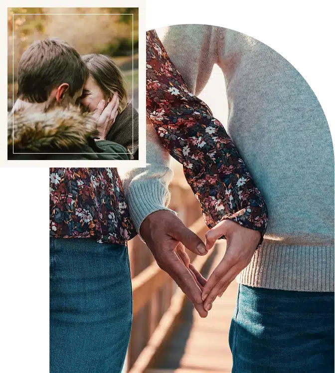 A couple holding hands while walking along a quiet riverbank