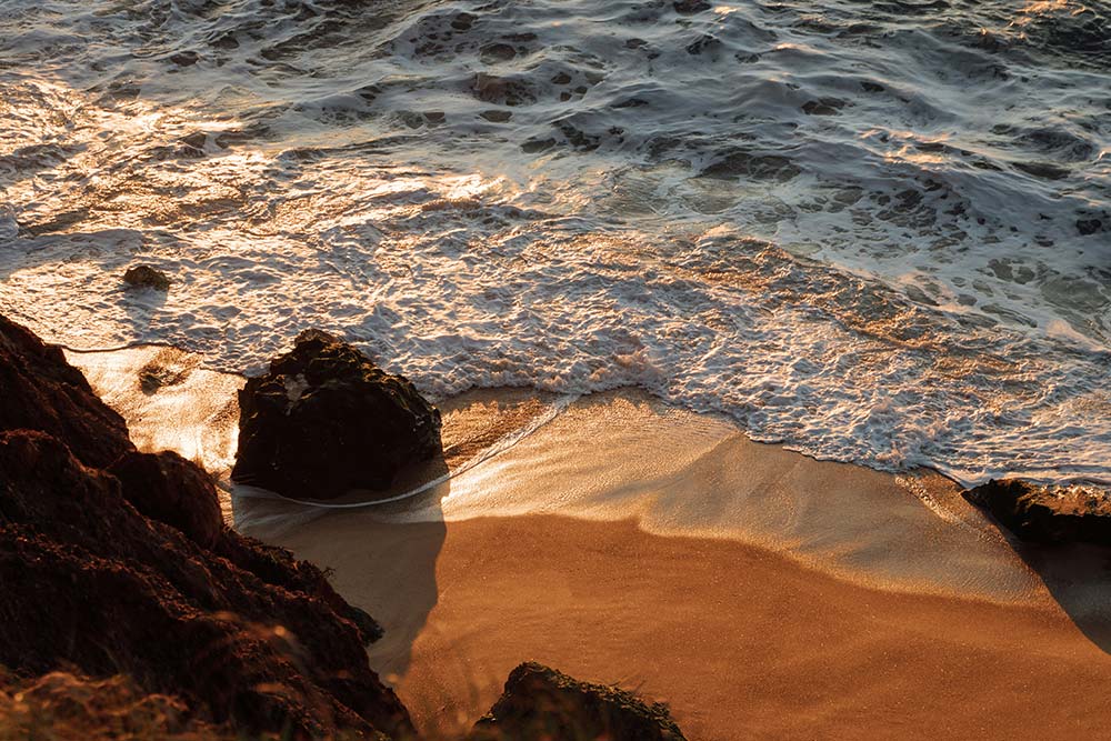 Ocean waves rolling onto a sandy beach, rhythmic movement evoking calm and renewal