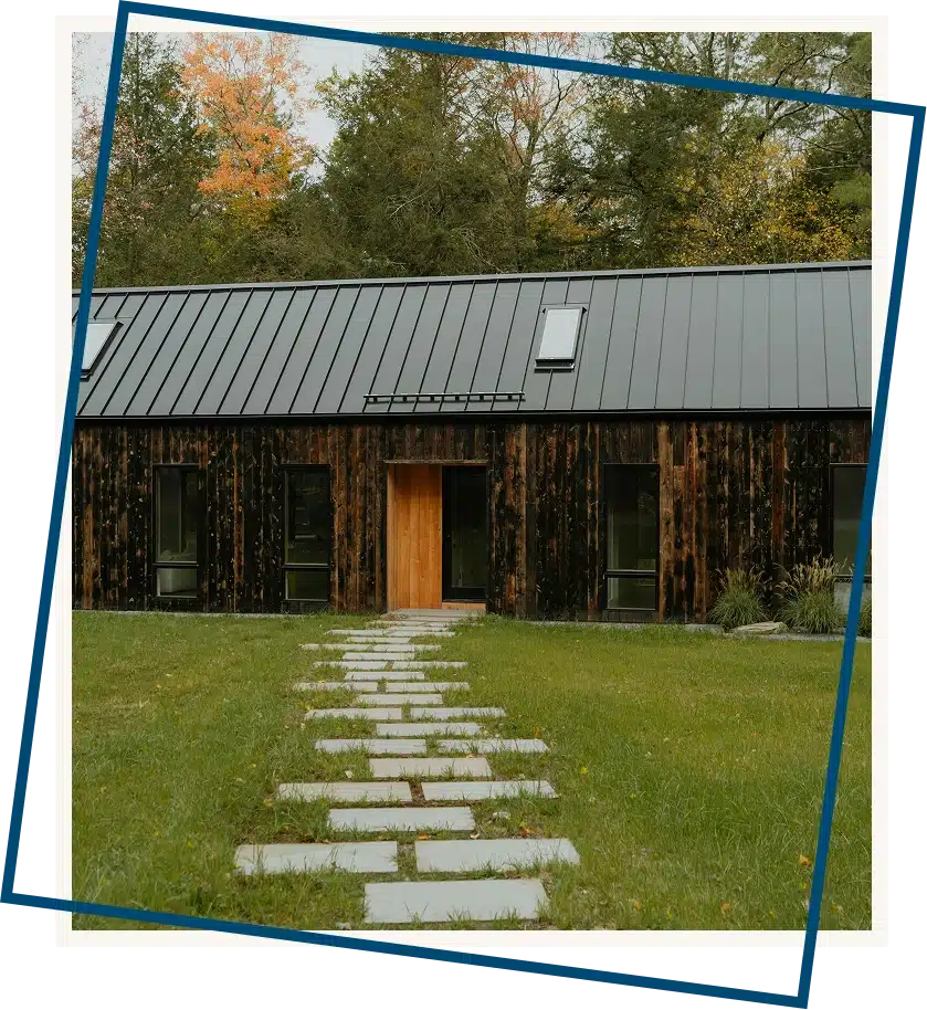 Small cottage with a winding path and trees in the background, quiet retreat in a natural setting