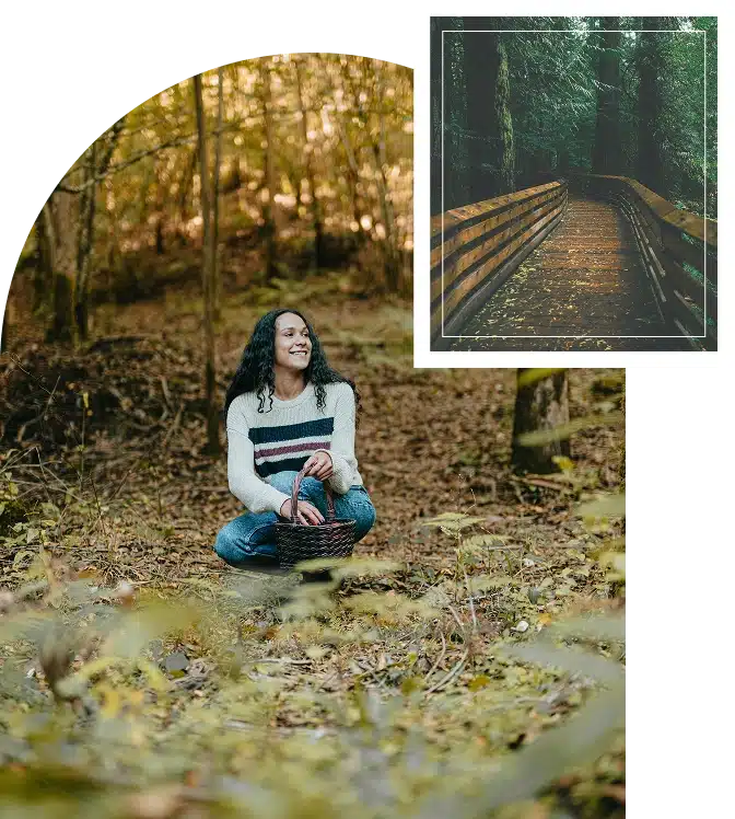 Woman sitting in a forest holding a basket, smiling softly in a warm, sunlit natural space