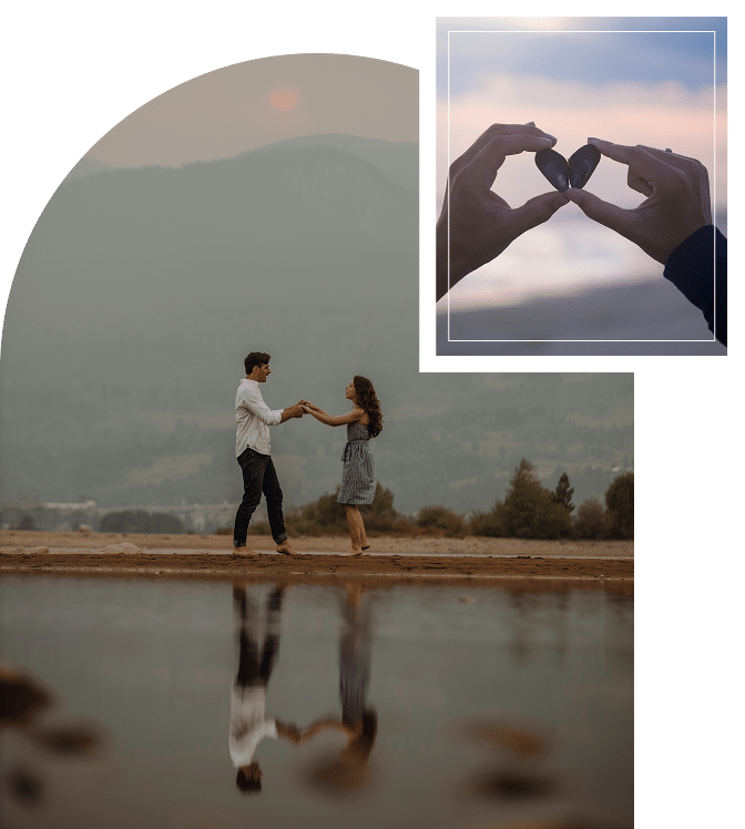 A couple embracing from behind with a scenic mountain view in front of them