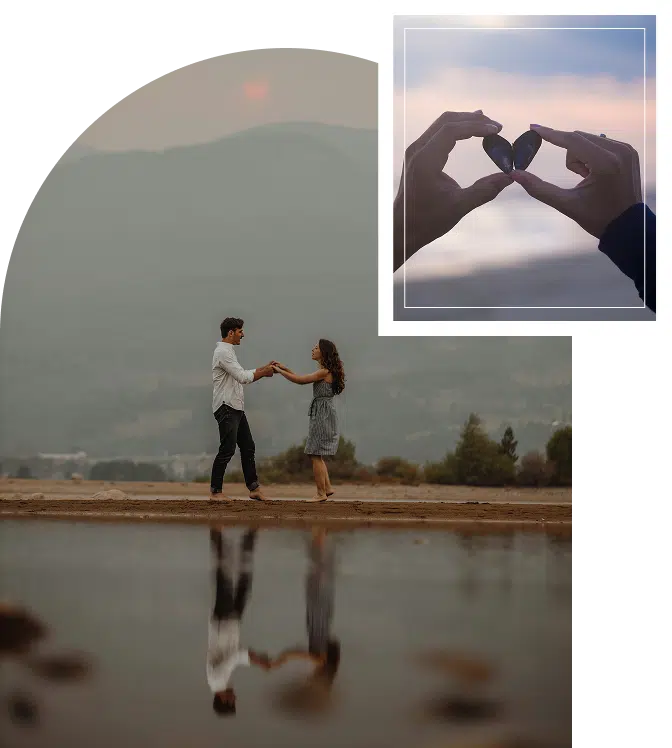 A couple embracing from behind with a scenic mountain view in front of them