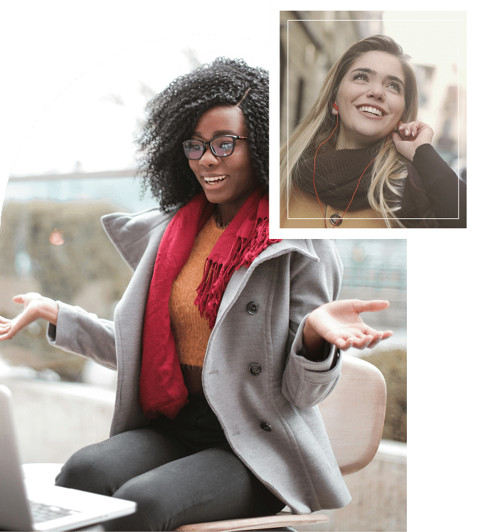 Two women smiling while talking, one on a laptop and the other walking on a phone call