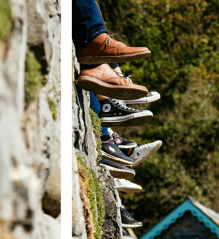 Group lying in a circle outdoors, feet toward the center, participating in a grounding group activity