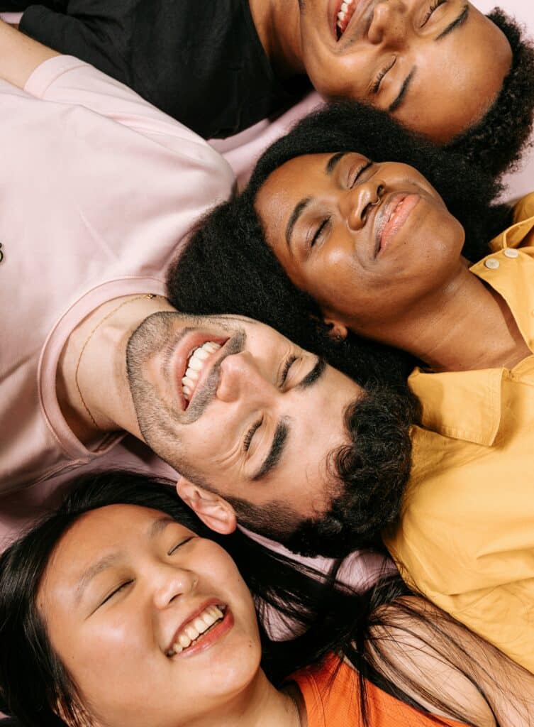 Group resting with eyes closed, appearing calm, grounded, and at ease during a guided exercise
