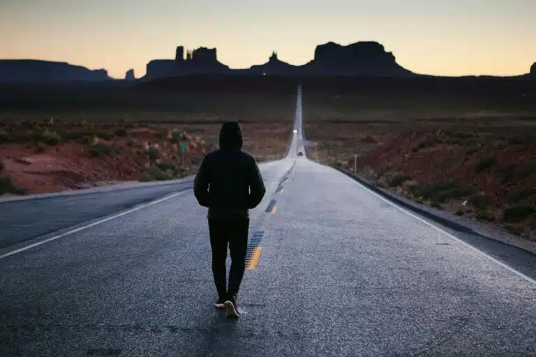 Man walking in the center of a road