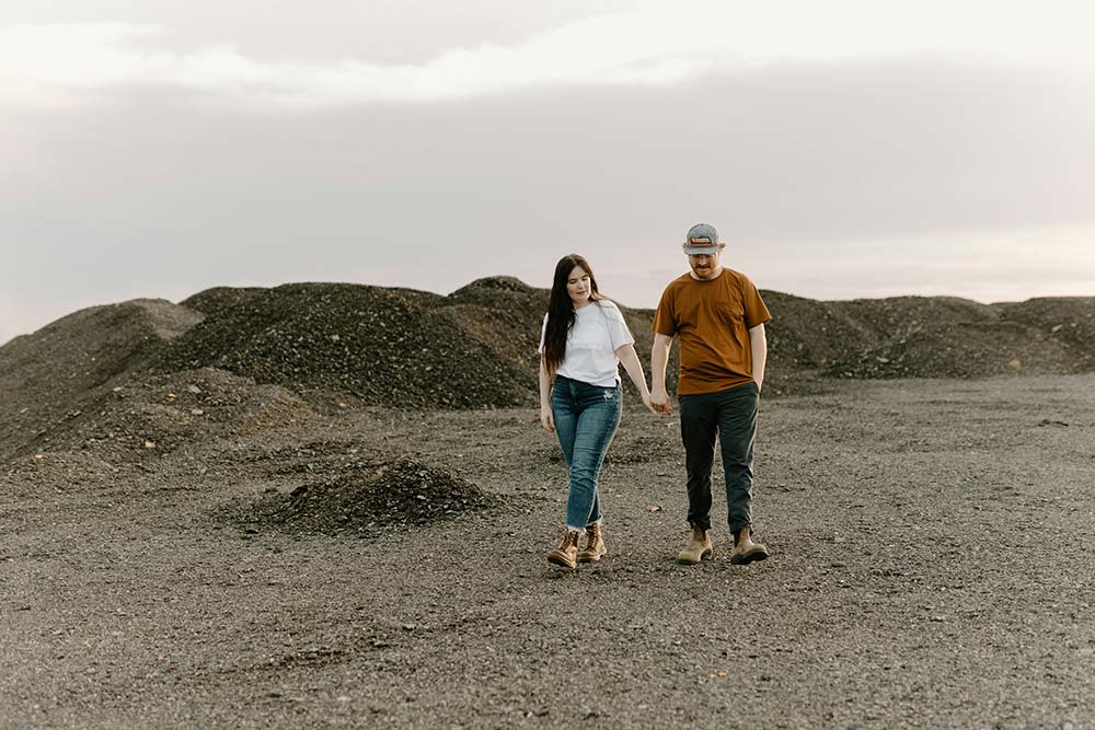 a man and a woman walking through a field