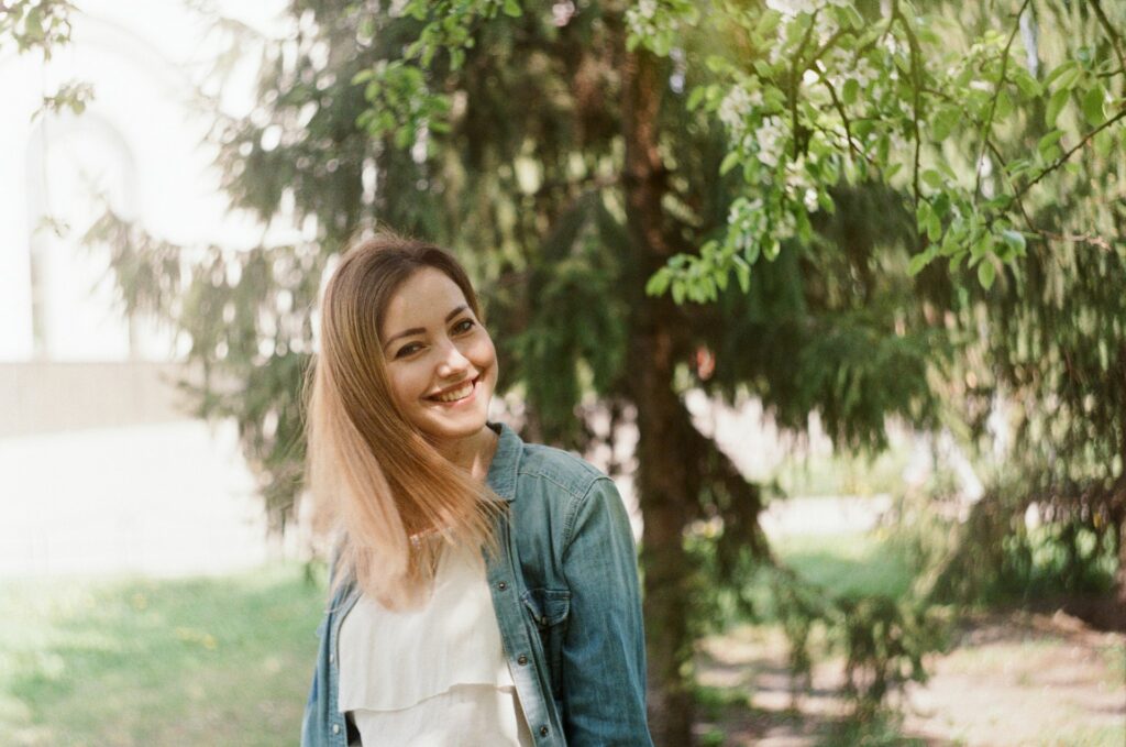 A woman in blue denim jacket smiling